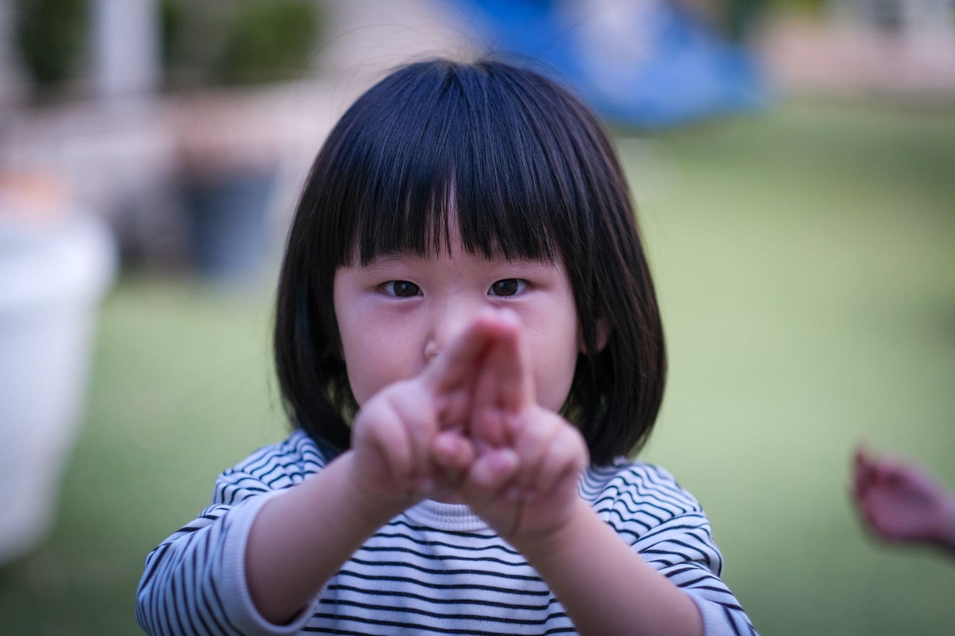 Close-up of two preschool friends sharing a happy moment together at Triton Montessori Educare, reflecting the centre's diverse, inclusive community