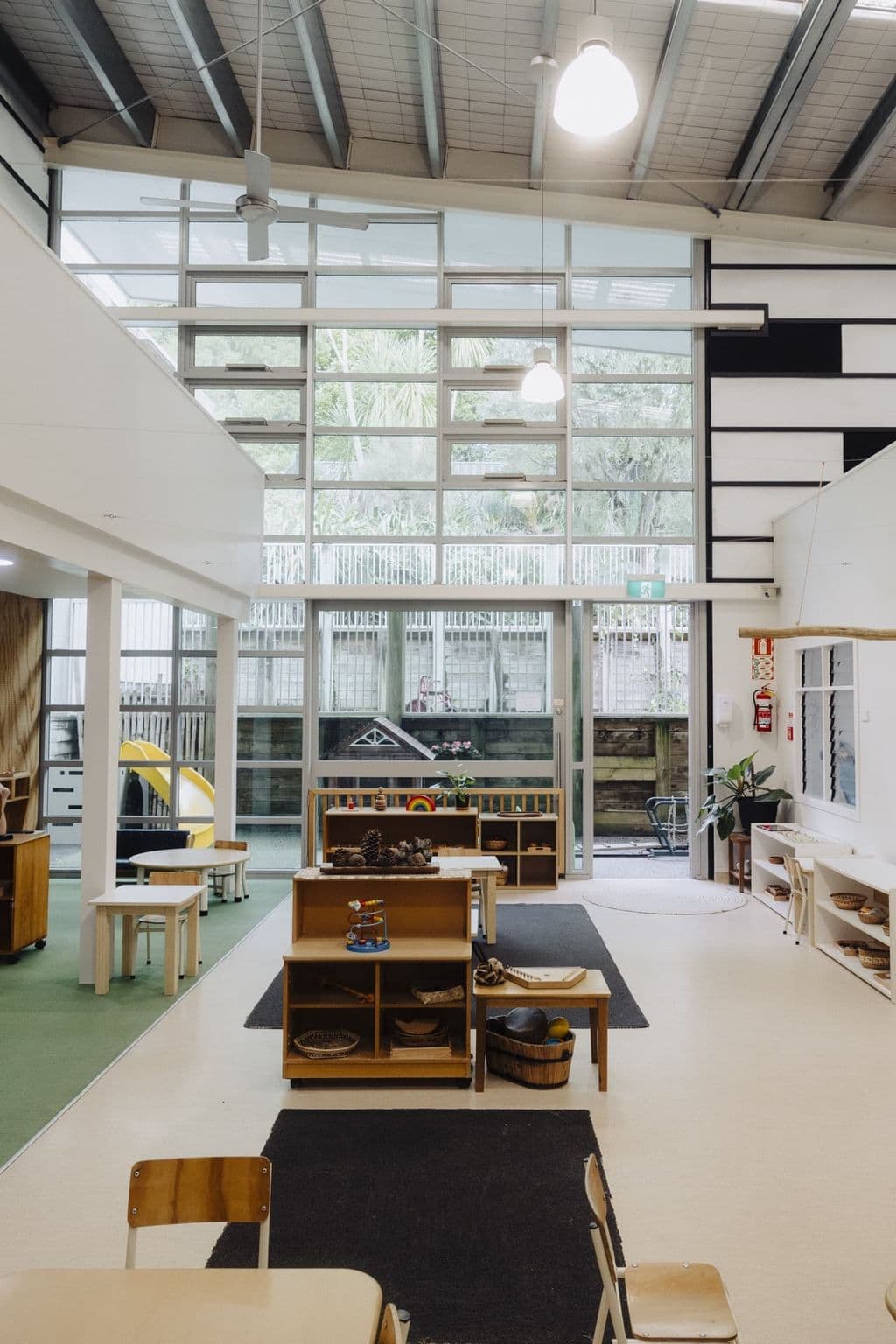 Spacious Montessori classroom with prepared shelves, rugs and natural light at Triton Montessori Educare