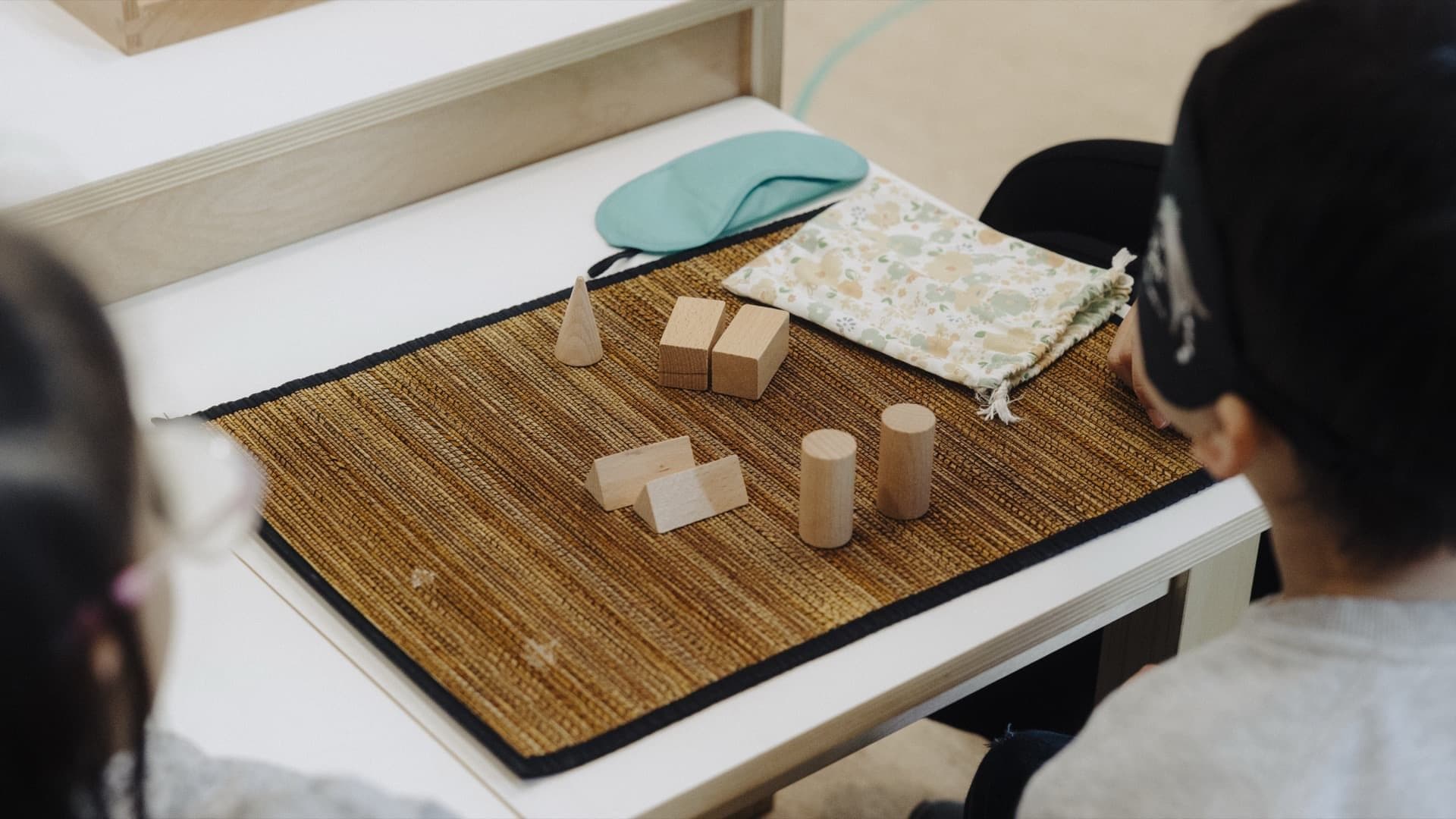 Montessori counting or threading activity arranged on a woven mat