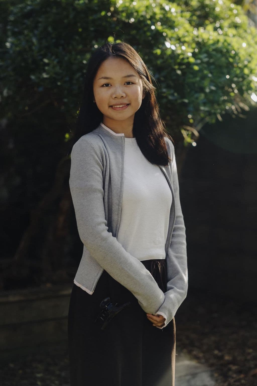 Triton Montessori team member portrait outdoors beside greenery