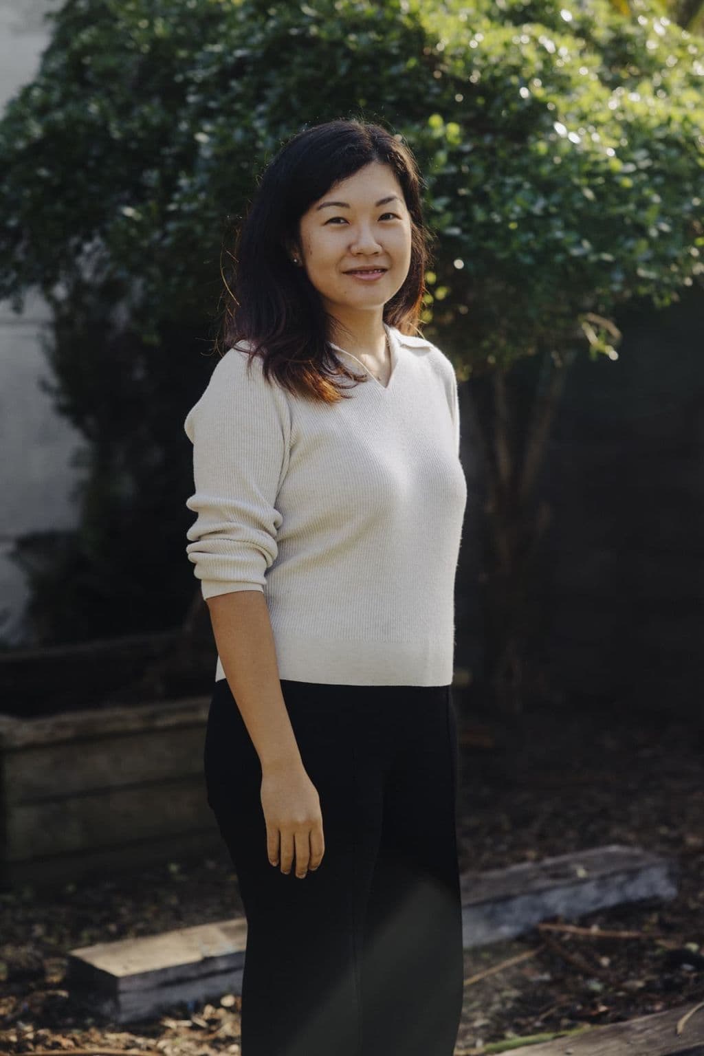 Triton Montessori team member in a cream sweater outdoors